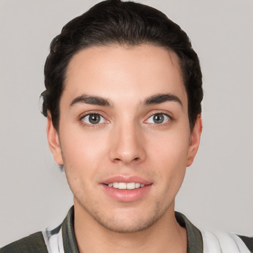 Joyful white young-adult male with short  black hair and brown eyes