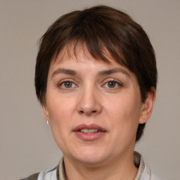 Joyful white adult female with medium  brown hair and brown eyes