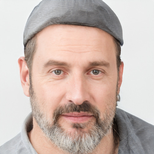 Joyful white adult male with short  brown hair and grey eyes