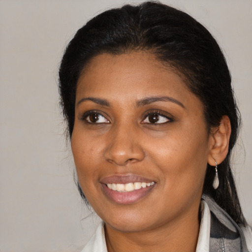 Joyful black young-adult female with medium  brown hair and brown eyes