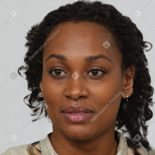 Joyful black adult female with medium  brown hair and brown eyes