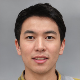 Joyful asian young-adult male with short  black hair and brown eyes