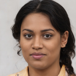 Joyful latino young-adult female with medium  brown hair and brown eyes