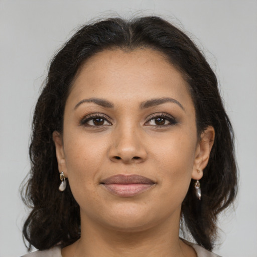 Joyful latino young-adult female with long  brown hair and brown eyes