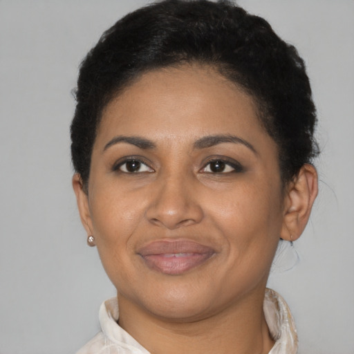 Joyful latino adult female with short  brown hair and brown eyes