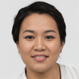 Joyful asian young-adult female with short  black hair and brown eyes