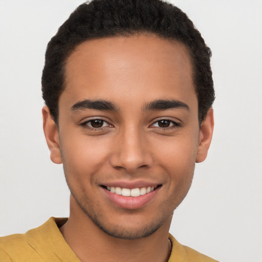 Joyful latino young-adult male with short  brown hair and brown eyes