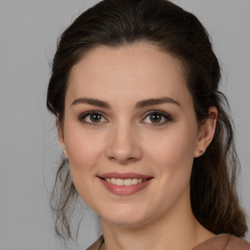 Joyful white young-adult female with medium  brown hair and brown eyes