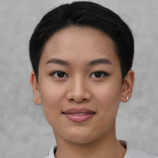 Joyful asian young-adult female with short  black hair and brown eyes