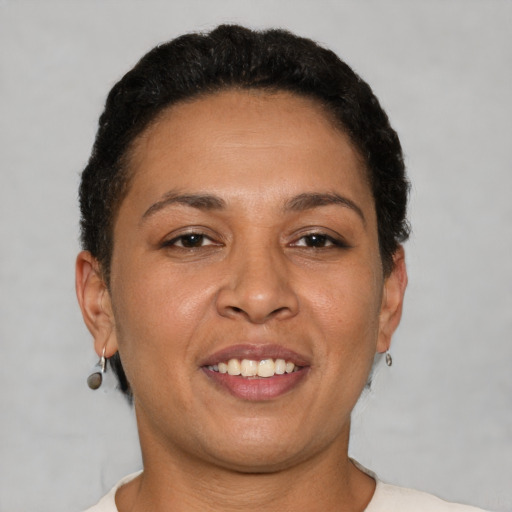 Joyful latino young-adult female with short  brown hair and brown eyes
