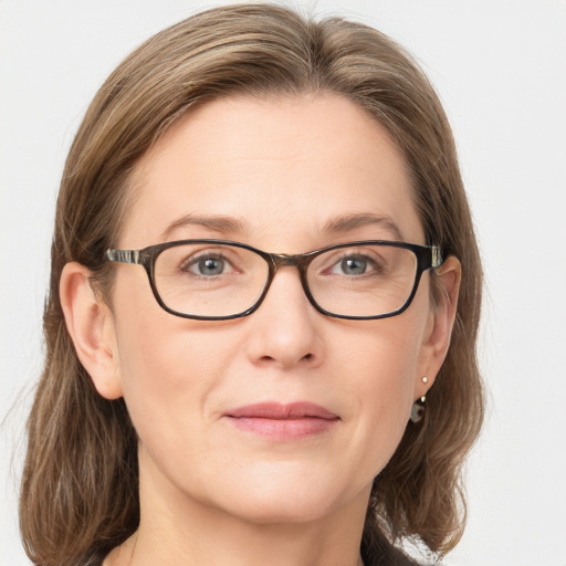 Joyful white adult female with medium  brown hair and blue eyes