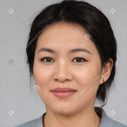 Joyful asian young-adult female with medium  black hair and brown eyes