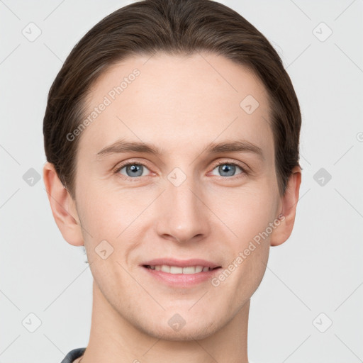 Joyful white young-adult male with short  brown hair and grey eyes