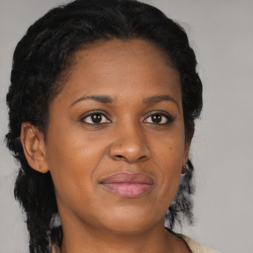 Joyful black young-adult female with medium  brown hair and brown eyes