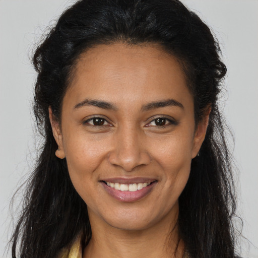Joyful latino young-adult female with long  brown hair and brown eyes