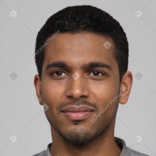 Joyful black young-adult male with short  black hair and brown eyes