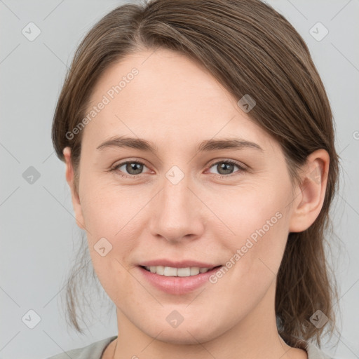 Joyful white young-adult female with medium  brown hair and grey eyes