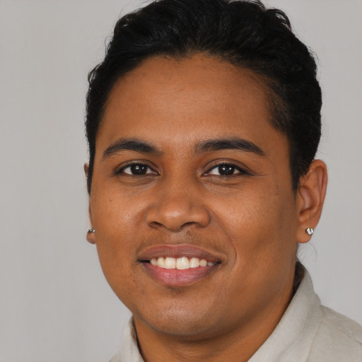Joyful black young-adult male with short  brown hair and brown eyes