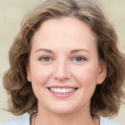 Joyful white young-adult female with medium  brown hair and green eyes