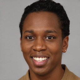 Joyful black young-adult male with short  brown hair and brown eyes