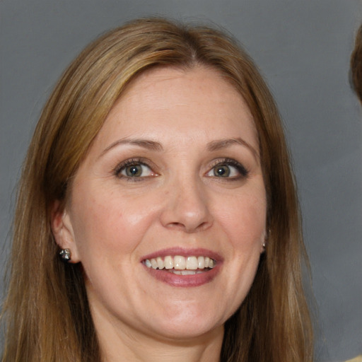 Joyful white adult female with long  brown hair and brown eyes