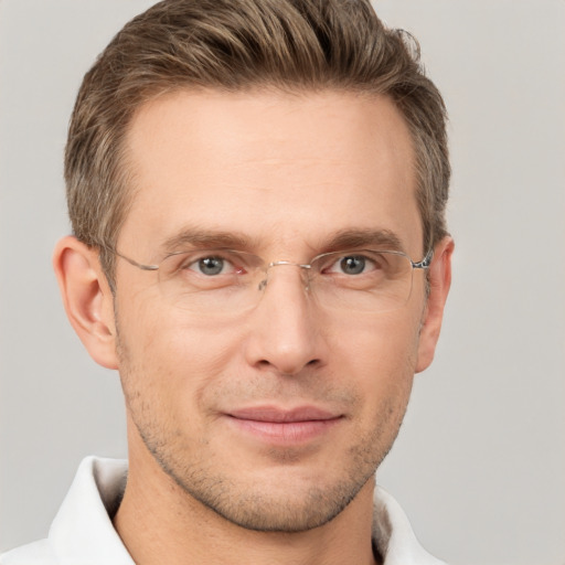 Joyful white adult male with short  brown hair and grey eyes