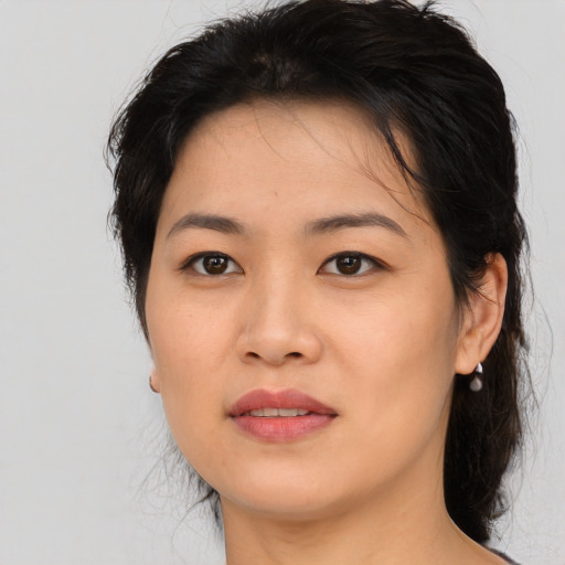 Joyful asian young-adult female with medium  brown hair and brown eyes