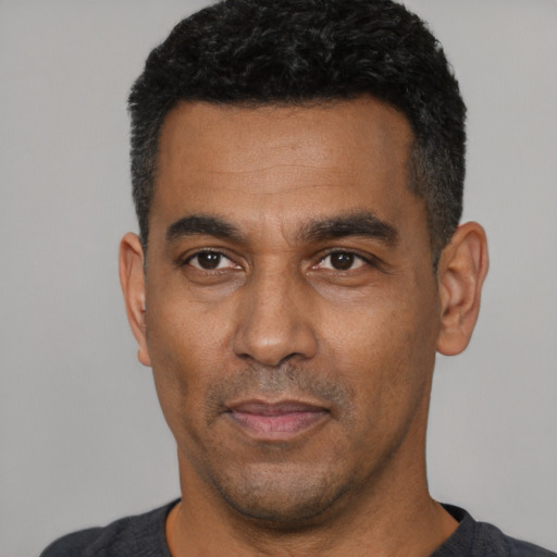 Neutral latino adult male with short  black hair and brown eyes
