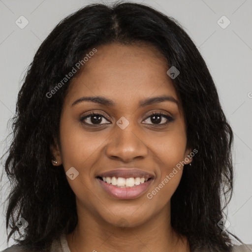 Joyful black young-adult female with long  black hair and brown eyes