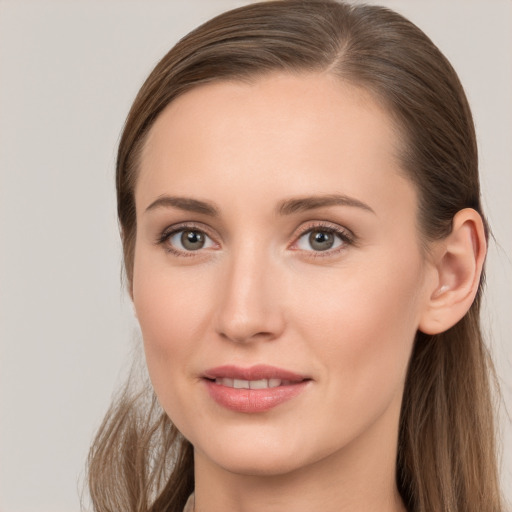 Joyful white young-adult female with long  brown hair and grey eyes