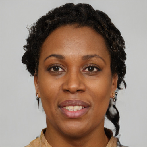 Joyful black adult female with short  brown hair and brown eyes