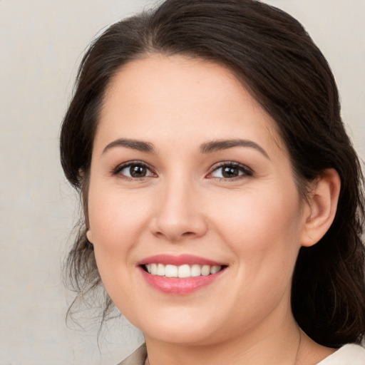 Joyful white young-adult female with medium  brown hair and brown eyes