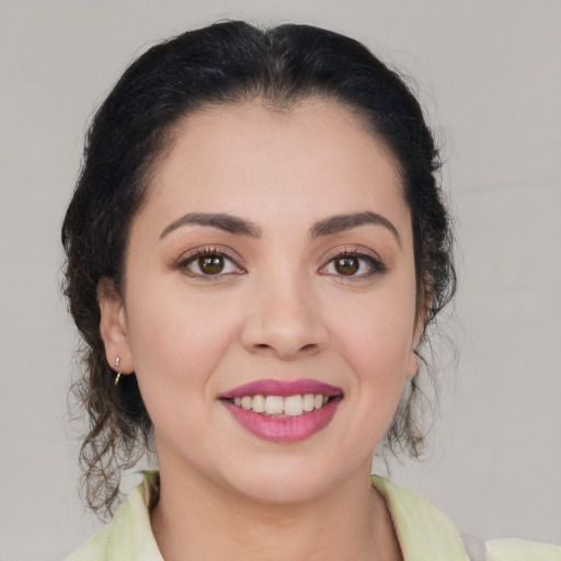 Joyful latino young-adult female with medium  brown hair and brown eyes
