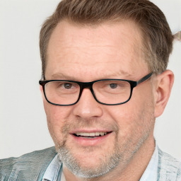 Joyful white middle-aged male with short  brown hair and blue eyes