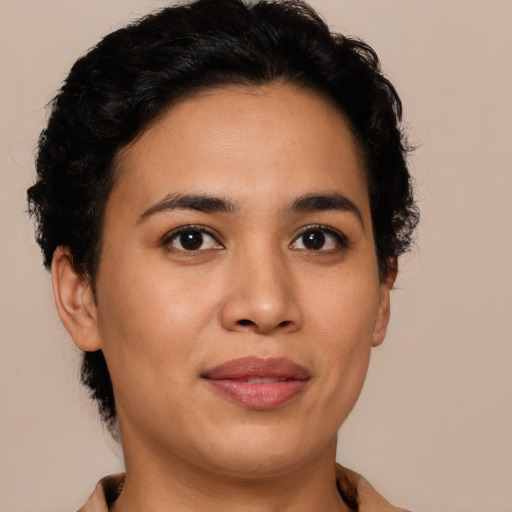Joyful latino young-adult female with short  brown hair and brown eyes