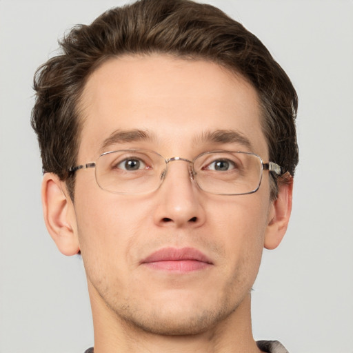 Joyful white adult male with short  brown hair and grey eyes