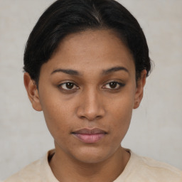 Joyful latino young-adult female with short  brown hair and brown eyes