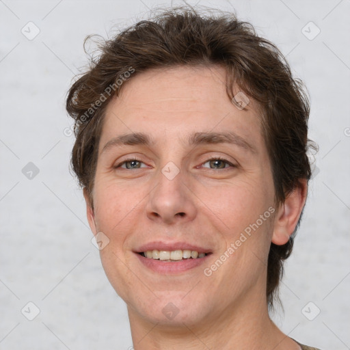 Joyful white adult male with short  brown hair and grey eyes