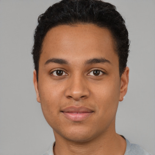 Joyful latino young-adult male with short  brown hair and brown eyes