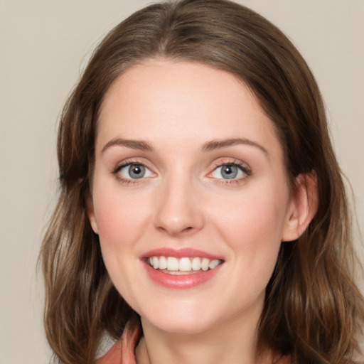 Joyful white young-adult female with long  brown hair and green eyes