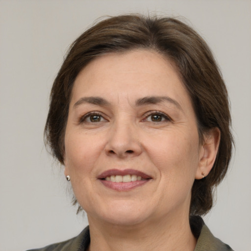 Joyful white adult female with medium  brown hair and grey eyes