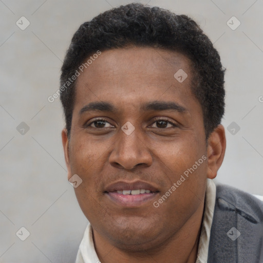 Joyful black young-adult male with short  brown hair and brown eyes