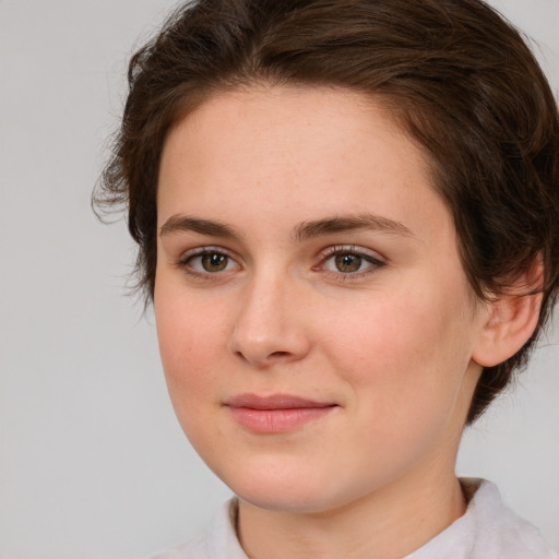 Joyful white young-adult female with medium  brown hair and green eyes