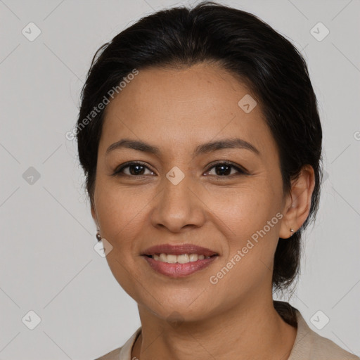 Joyful latino young-adult female with medium  brown hair and brown eyes