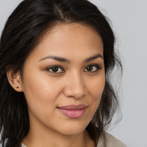 Joyful latino young-adult female with medium  brown hair and brown eyes