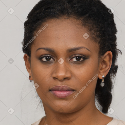 Joyful black young-adult female with long  brown hair and brown eyes