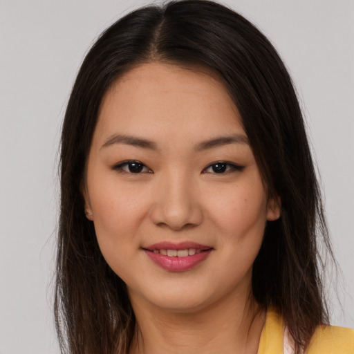 Joyful asian young-adult female with long  brown hair and brown eyes