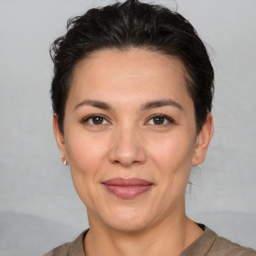 Joyful white adult female with short  brown hair and brown eyes