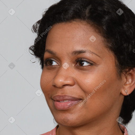 Joyful black adult female with short  brown hair and brown eyes