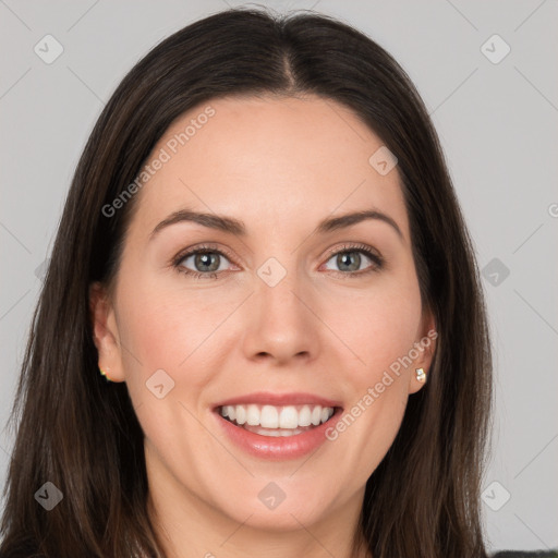 Joyful white young-adult female with long  brown hair and brown eyes